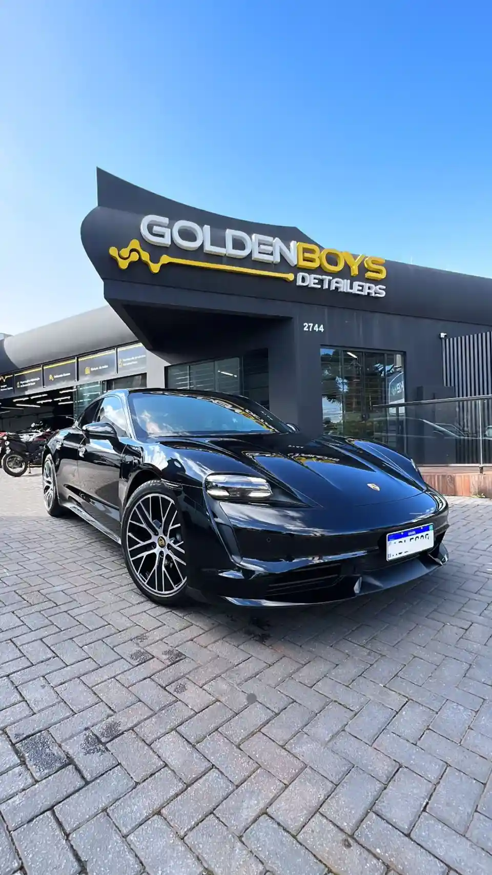 Porsche Taycan preto na fachada